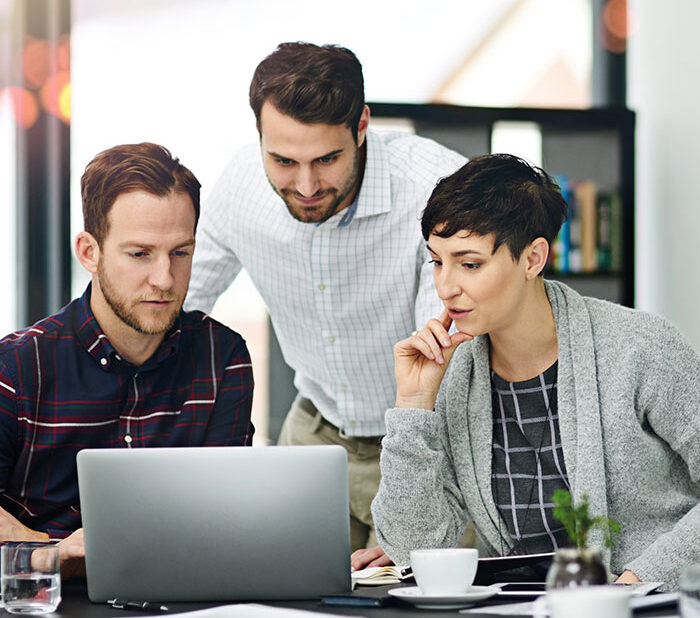 Business, people and meeting in boardroom with laptop for discussion on teamwork, collaboration on project. Office, strategy and ideas in startup company with reviews, report and feedback for growth.